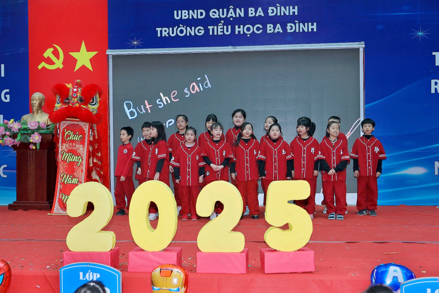 A group of children performing on stage

Description automatically generated