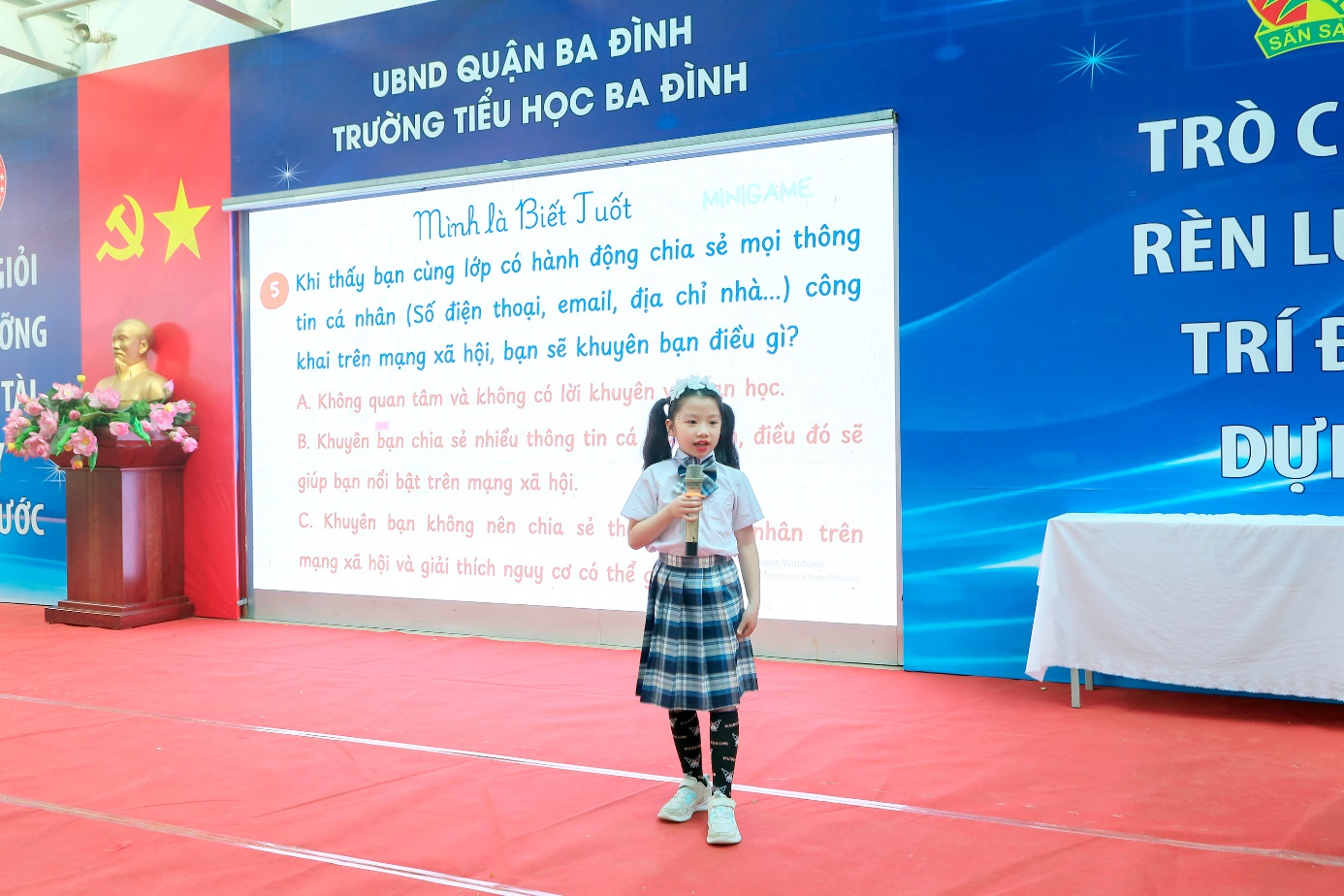 A child standing on a red carpet

Description automatically generated