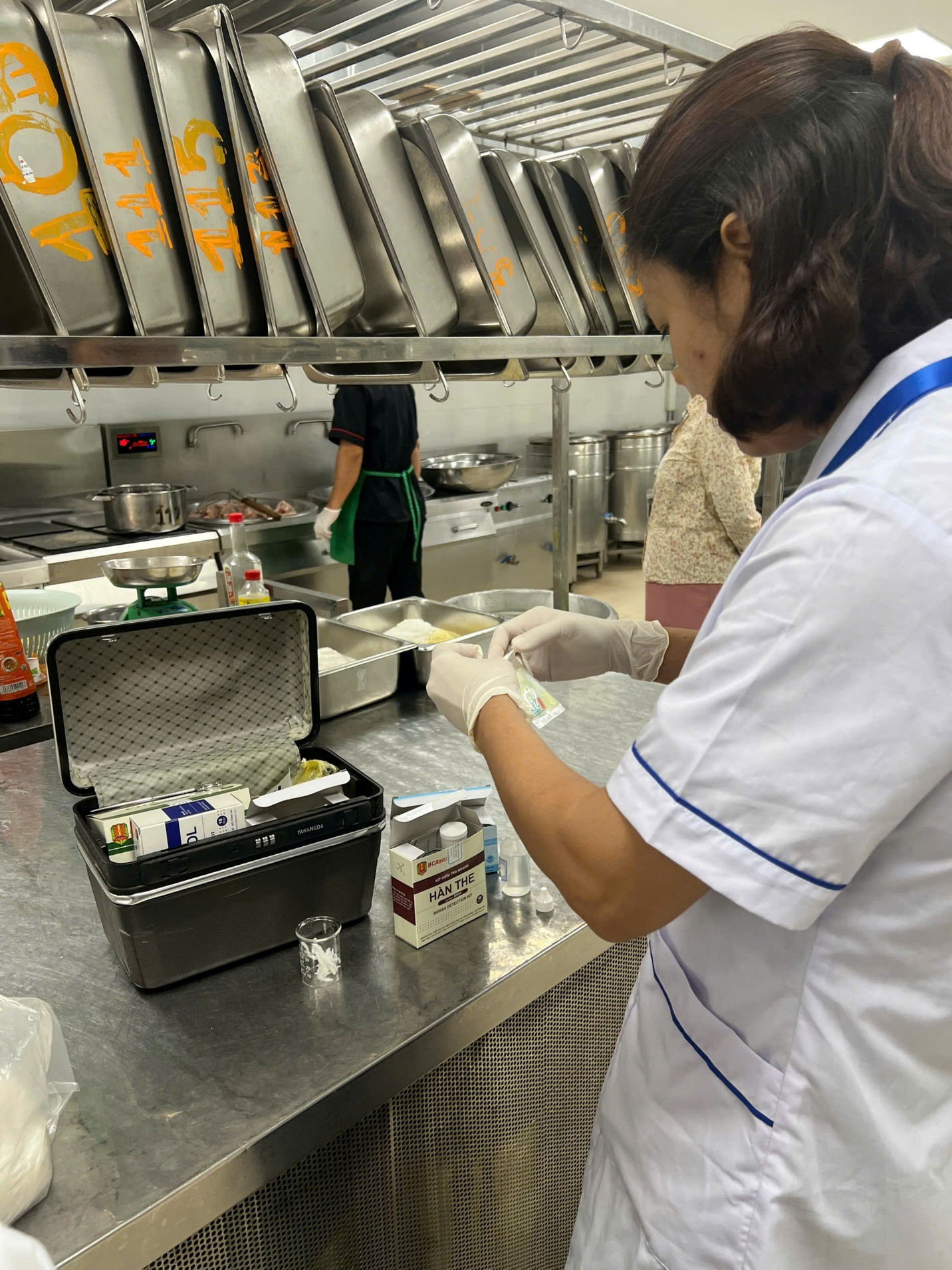 A person in a white coat and gloves in a kitchen

AI-generated content may be incorrect.