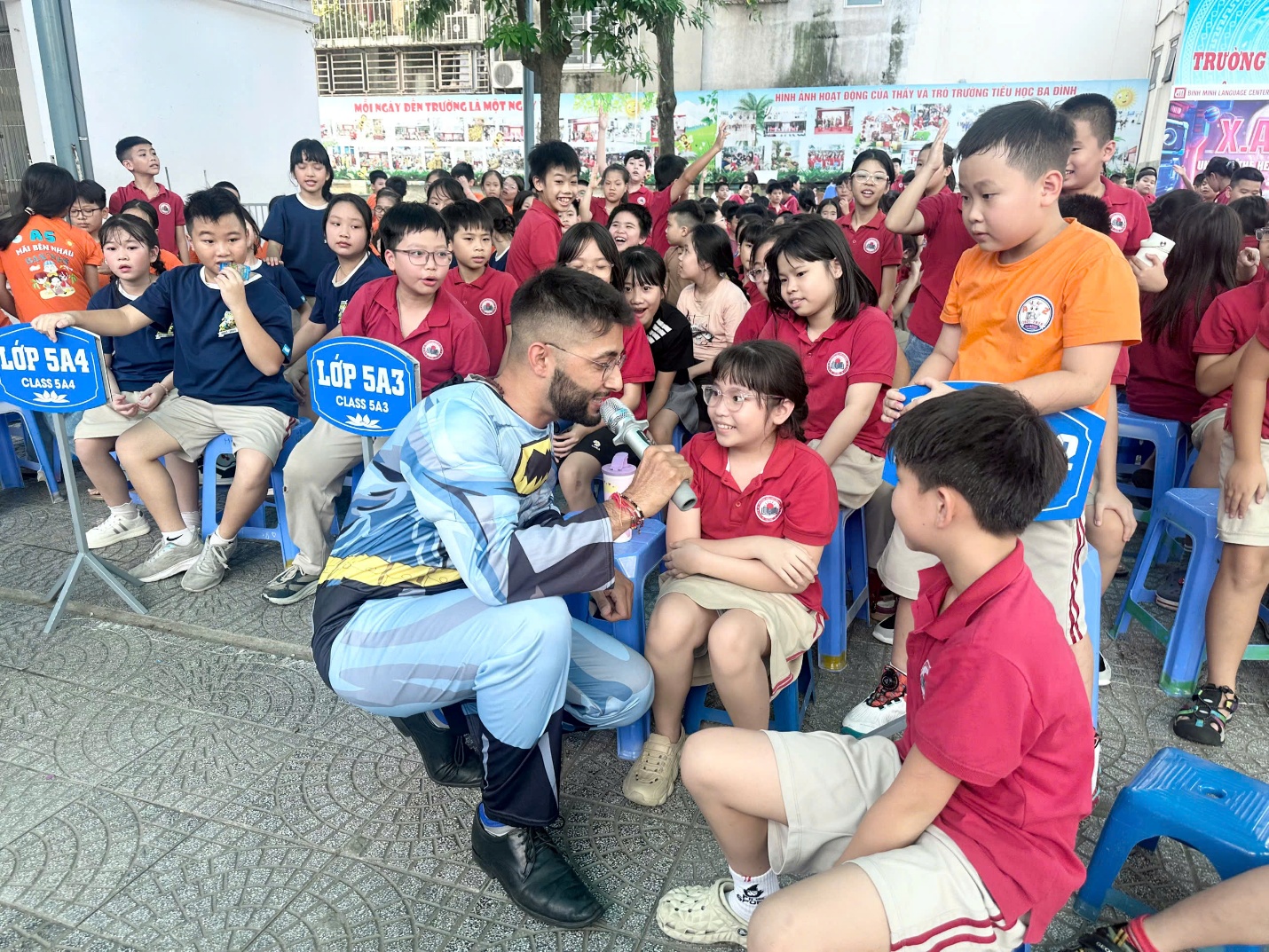 A person sitting on a chair with a group of kids

AI-generated content may be incorrect.