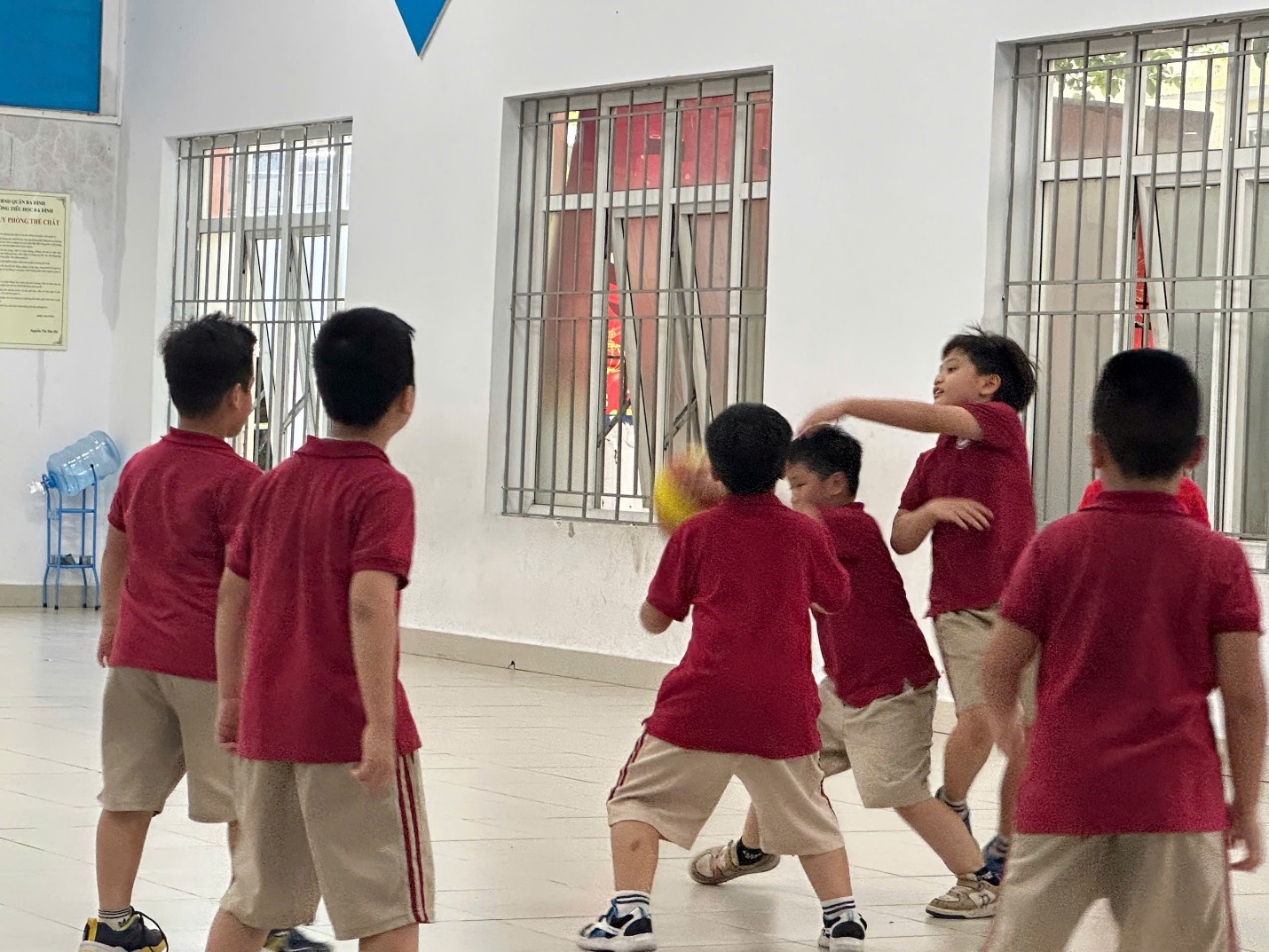 A group of boys in red shirts playing with a ball

AI-generated content may be incorrect.