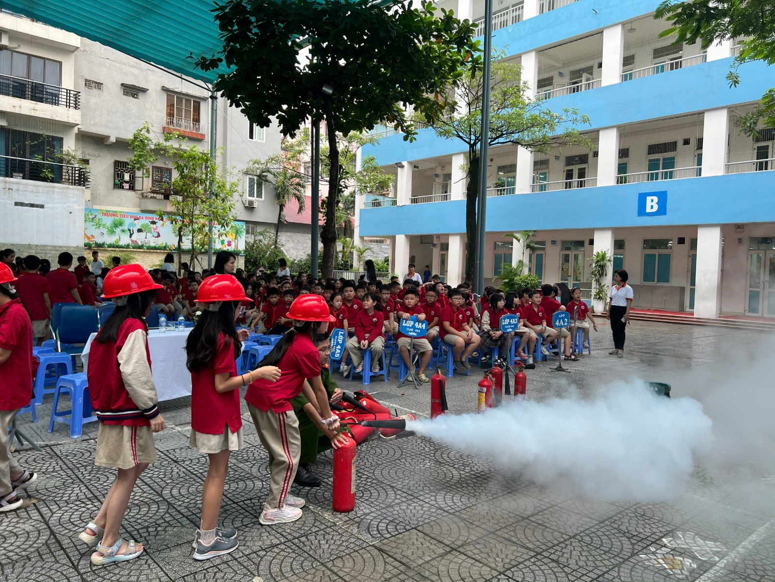 A group of people in red helmets spraying fire extinguisher

AI-generated content may be incorrect.
