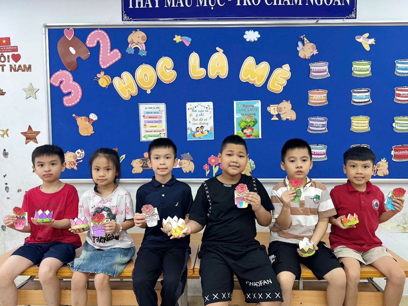 A group of children sitting on a bench

AI-generated content may be incorrect.