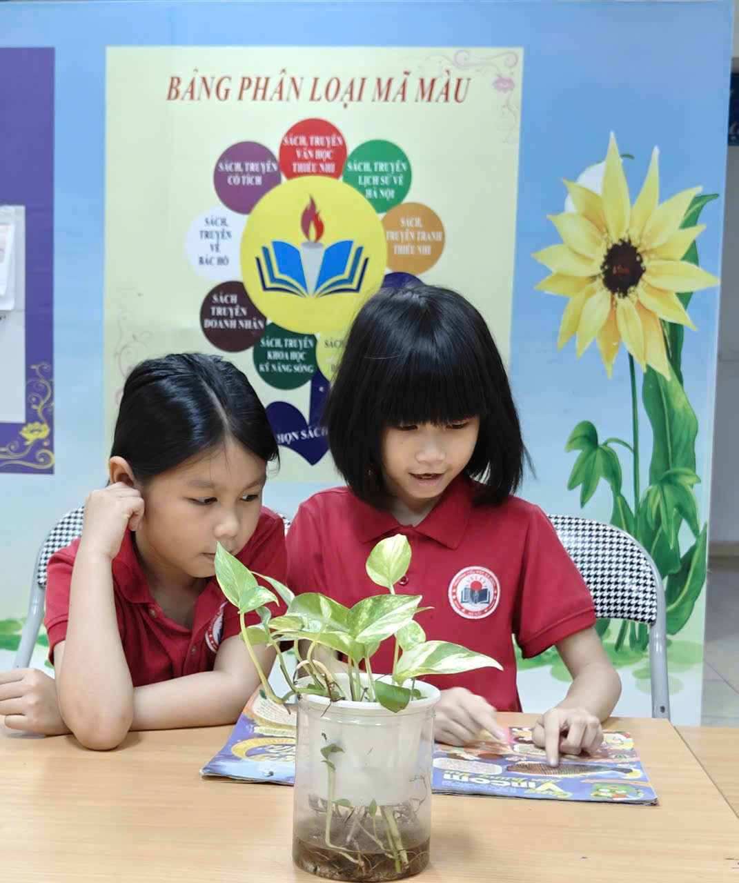 A couple of girls sitting at a table looking at a plant

AI-generated content may be incorrect.