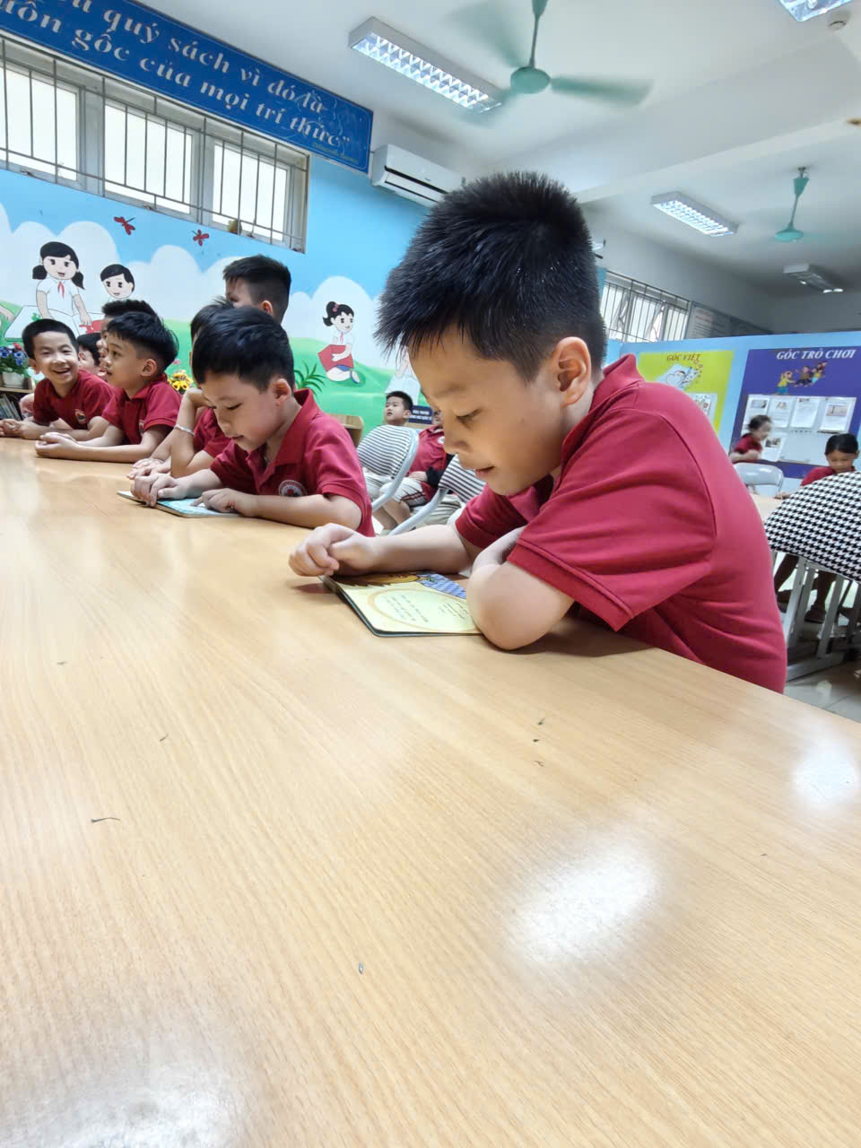 A group of children sitting at a table

AI-generated content may be incorrect.