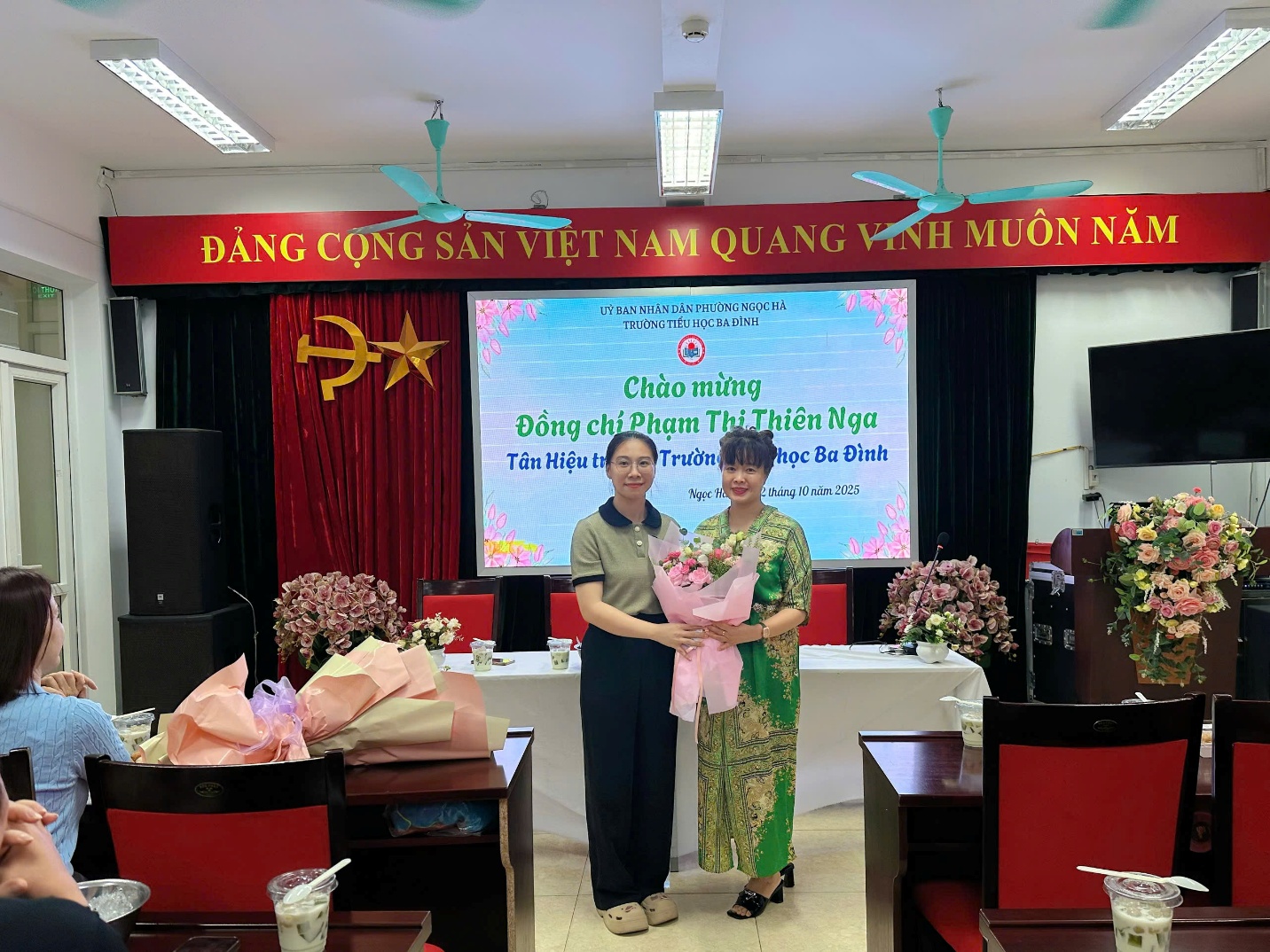 A person and person standing in front of a screen

AI-generated content may be incorrect.