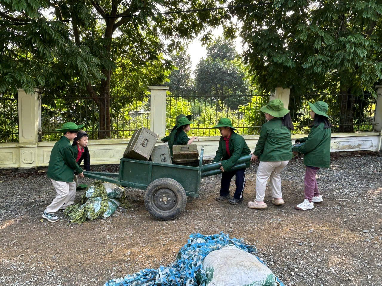 A group of people in green jackets pushing a cart with a cart

AI-generated content may be incorrect.
