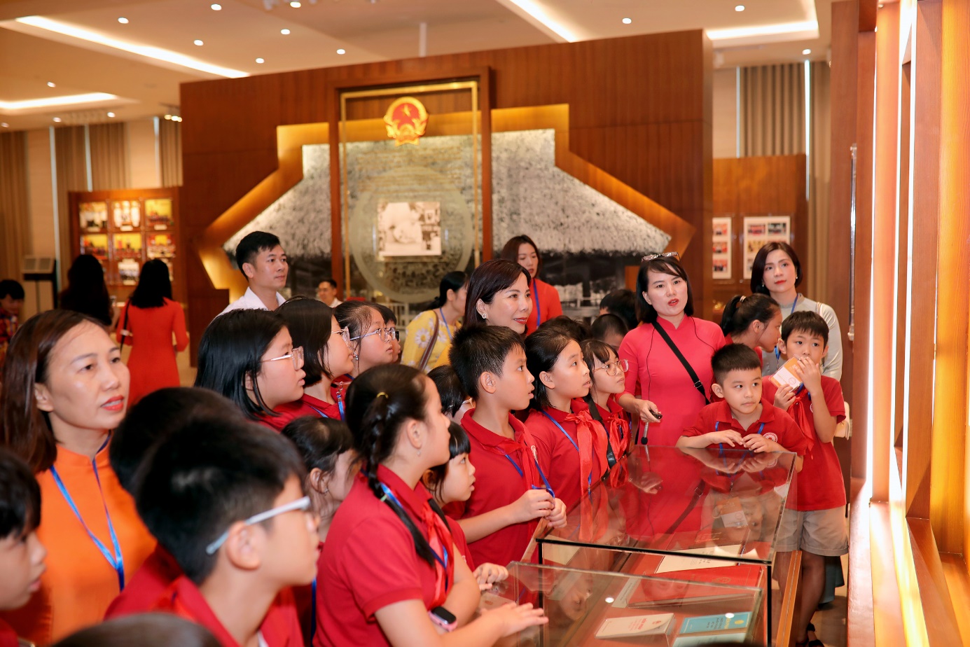 A group of people in red shirts

Description automatically generated