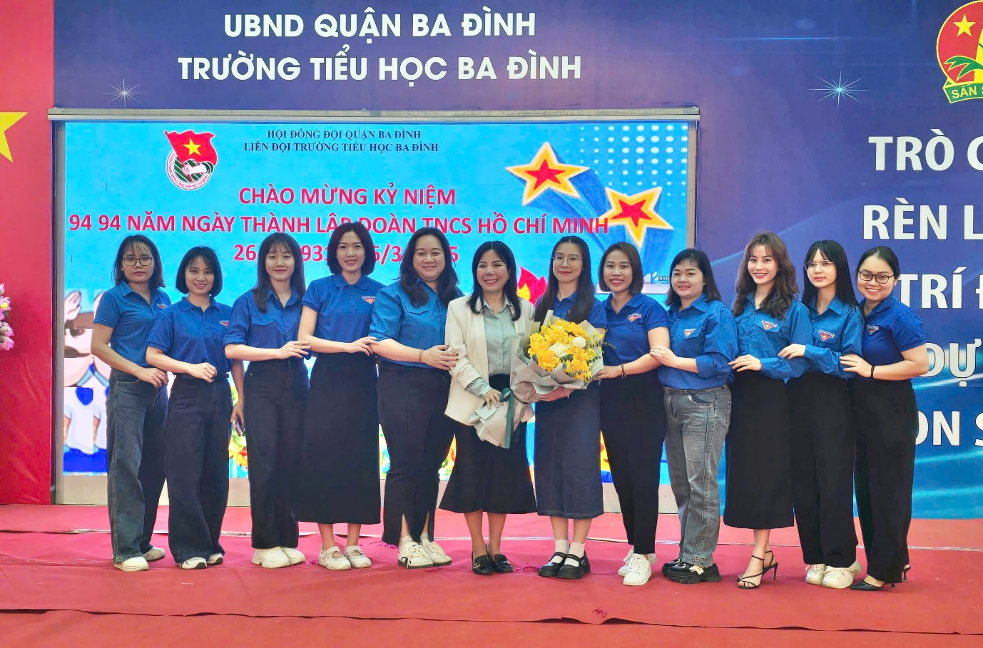 A group of women standing on a stage

AI-generated content may be incorrect.