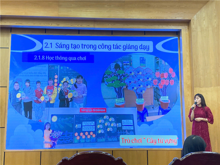 A person standing in front of a screen

Description automatically generated