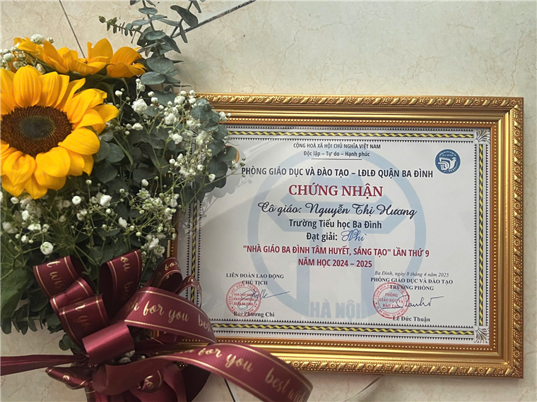 A certificate and flowers in a gold frame

Description automatically generated