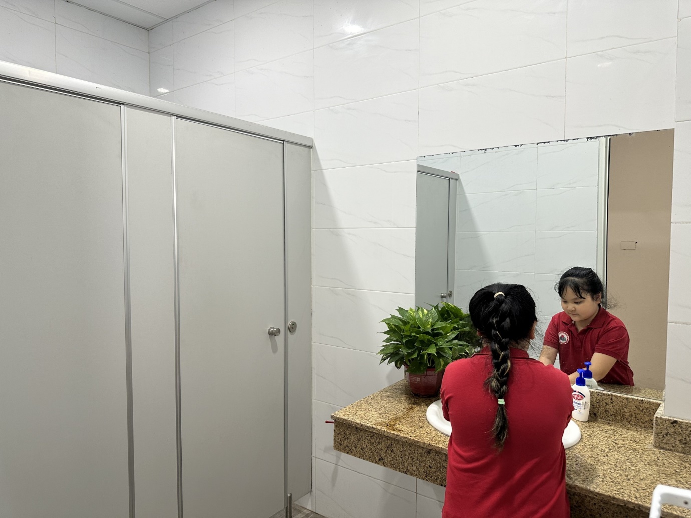 A person and child in a bathroom

Description automatically generated