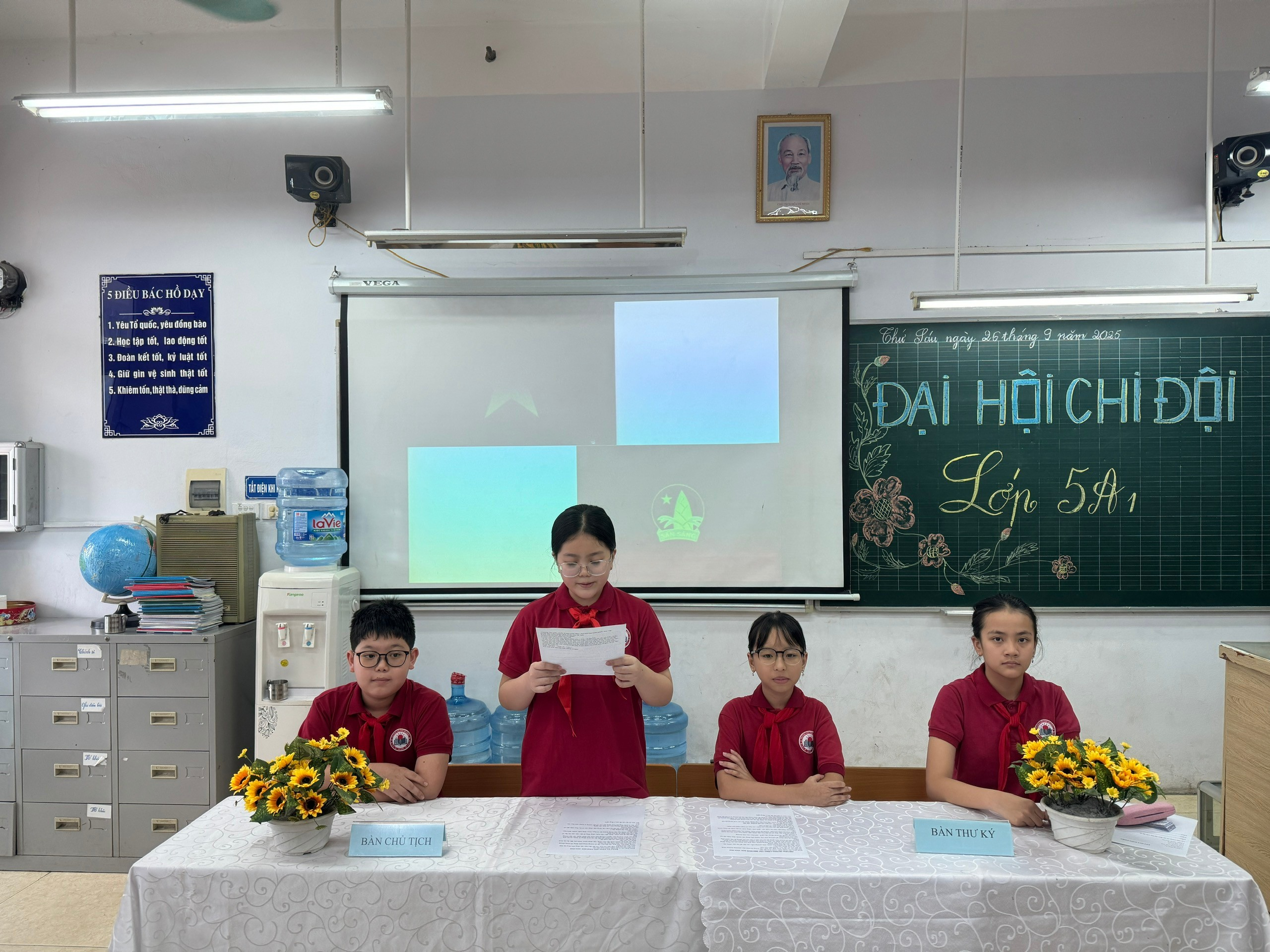 A group of students sitting at a table in a classroom

AI-generated content may be incorrect.